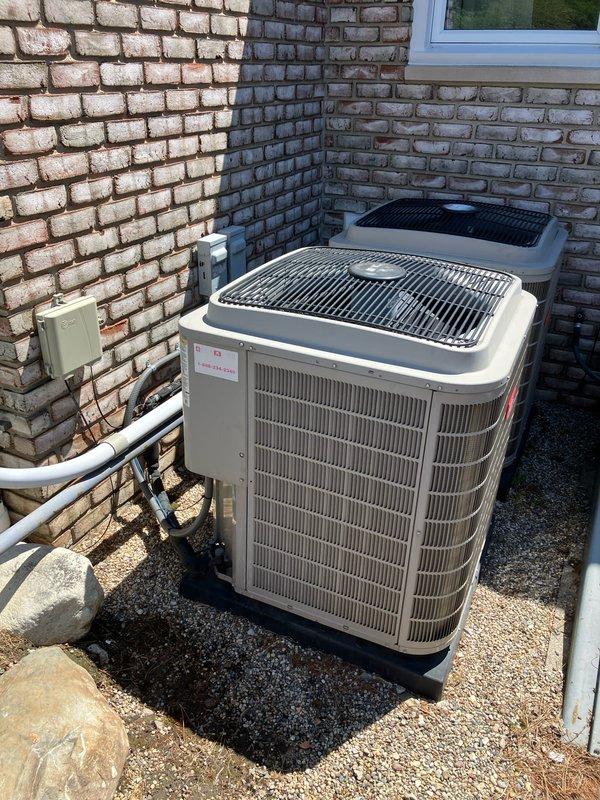 Conducted comprehensive inspection and prepared replacement estimate for 10-year-old AC unit #1 located in basement. Evaluated existing outdoor condensing units positioned against brick exterior wall with proper electrical disconnect and drainage systems in place. Assessment included indoor air quality concerns with specific request for CO2 level testing. Equipment currently operational at time of inspection, allowing for thorough performance evaluation and accurate replacement specifications.