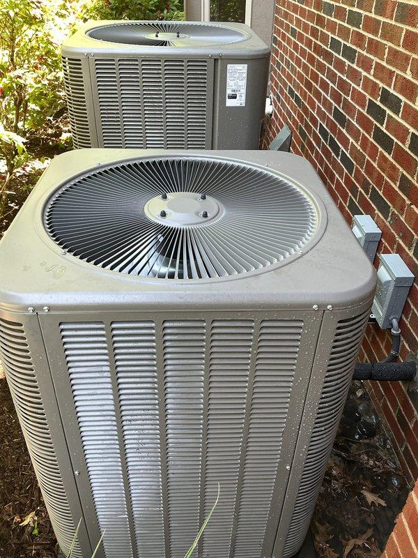 Completed prepaid maintenance visit and documented existing HVAC equipment for customer requesting quote on two Nest thermostat installations. Inspected outdoor condensing units, both under 10 years old, and photographed equipment configuration including evaporator coil location in basement for estimate preparation.