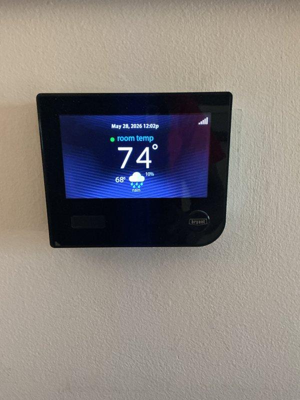 # HVAC Maintenance - Gold AC Inspection

Completed comprehensive Gold-level preventative maintenance inspection on a seven-year-old residential air conditioning system located at the rear of the property. Upon arrival, verified the Bryant programmable thermostat was functioning properly, displaying accurate room temperature of 74°F with proper system communication and control response.

Proceeded to the mechanical room where the HVAC equipment is installed alongside the water heating system. Performed thorough multi-point inspection of the air conditioning unit including:

- Visual inspection of all accessible components for wear, damage, or deterioration
- Checked refrigerant levels and pressures to ensure optimal system performance
- Inspected electrical connections, contactors, and capacitors for proper operation
- Cleaned condenser coils to maximize heat transfer efficiency
- Verified proper drainage from condensate line
- Tested system startup and shutdown sequences
- Measured tem