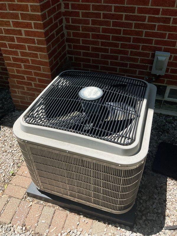 Completed non-service plan air conditioning inspection on a 10-year-old residential cooling system with air handler located in basement. Unit was operational at time of inspection, exterior condenser showed normal wear consistent with age, and all accessible components were documented through photographic records including manufacturer data plate showing R-410A refrigerant specifications and model information.