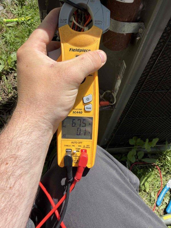 Responded to no-cooling complaint on Lennox model 23M-12 air conditioning system. Upon arrival, found refrigerant line had been severed to outdoor condenser unit. Inspected damaged copper line and assessed extent of repair needed. Measured electrical parameters at condenser, recording 6.75 amp draw to verify compressor operation capability once refrigerant circuit restored. Documented equipment condition and line damage with photographic evidence for property management and repair authorization.