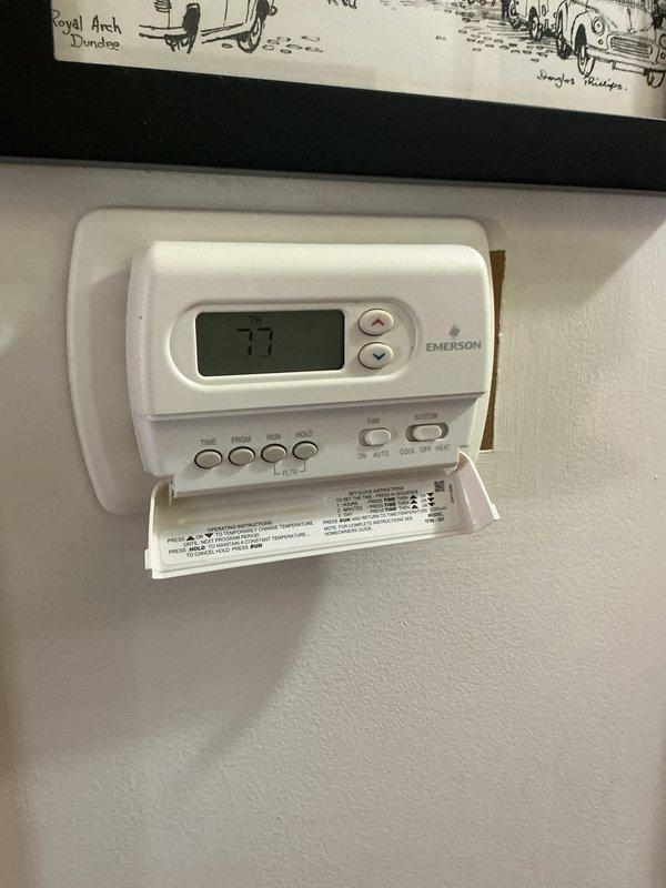 Completed comprehensive Gold AC inspection on 7-year-old residential air conditioning system with air handler/coil located in basement. Verified system operational status and confirmed single-unit configuration. Performed standard multi-point inspection protocol including refrigerant levels, electrical connections, condensate drain functionality, air filter condition, thermostat calibration, and overall system performance. Documented equipment specifications and current operating conditions through photographic records of thermostat controls and related mechanical systems. All components found functioning within normal parameters with no immediate service needs identified at time of inspection.
