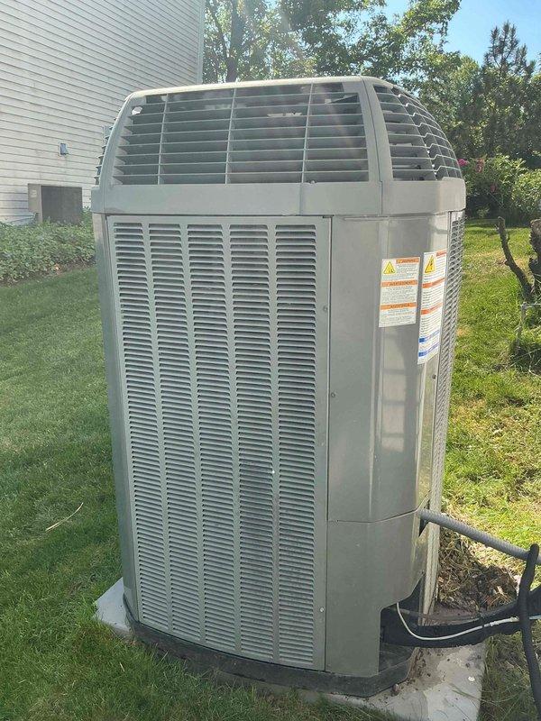 Completed comprehensive Gold-level preventive maintenance inspection on a 14-year-old Trane residential air conditioning system. Unit showed no reported operational issues prior to service. Performed thorough visual examination of outdoor condenser unit, confirming proper installation on concrete pad with adequate clearance and airflow. Inspected electrical connections, refrigerant lines, and condensate drainage components. Verified all safety labels and manufacturer specifications remained legible and intact. Unit appeared to be in normal operating condition consistent with age, with typical outdoor weathering on metal casing. Documented equipment condition through photographic records. System is scheduled for next maintenance in 2026.