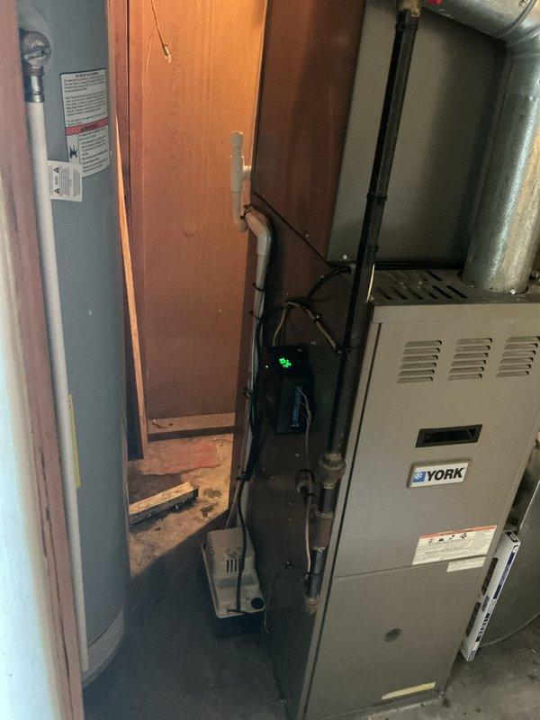 Completed installation of new air conditioning system and evaporator coil in residential utility room. System was properly connected to existing York furnace, all refrigerant lines and ductwork were installed per manufacturer specifications, and electrical connections were completed. Unit was tested for proper operation, permit was requested for the installation, and customer payment was processed in full.