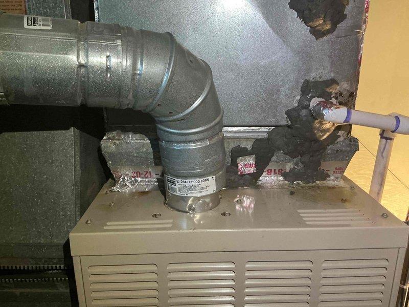 Responded to callback for water leak issue on 10+ year old AC system located in basement. Upon arrival after 3 PM, inspected air handler and condensate drainage system where water accumulation had been reported on top of furnace. Used digital multimeter to perform electrical diagnostics and verify system operation. Tested capacitor functionality to ensure proper compressor and fan motor operation. Examined ductwork connections and air handler cabinet for signs of condensation or drain line blockage. Photographed HVAC installation including ductwork configuration and electrical components for documentation purposes. Addressed water leakage concern and cleared system for operation after completing diagnostics and necessary repairs to condensate management system.
