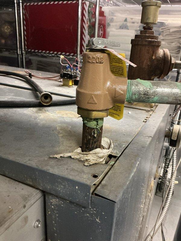 Responded to service call for boiler leak in basement. Upon inspection, found significant corrosion and green patina on copper piping at valve assembly connections, indicating active oxidation and potential leak source. Examined circulator pump and associated plumbing components, noting age-related wear on pump housing and valve bodies. System remained operational with heating function intact despite leak condition. Documented corroded copper pipe sections, brass valve assemblies, and circulation pump showing approximately 10+ years of service life. Recommended monitoring leak progression and scheduling follow-up repairs to address corroded piping and valve connections before system failure occurs.