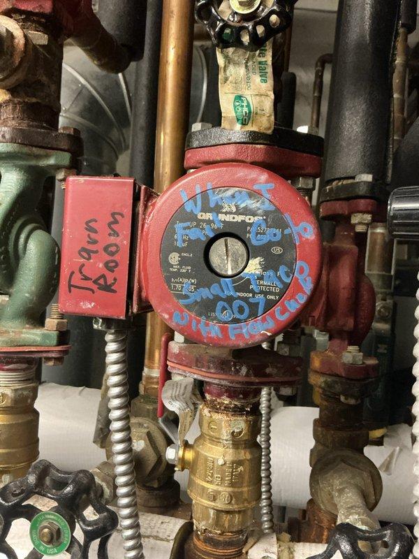 Responded to service call for boiler leak in basement. Upon inspection, found significant corrosion and green patina on copper piping at valve assembly connections, indicating active oxidation and potential leak source. Examined circulator pump and associated plumbing components, noting age-related wear on pump housing and valve bodies. System remained operational with heating function intact despite leak condition. Documented corroded copper pipe sections, brass valve assemblies, and circulation pump showing approximately 10+ years of service life. Recommended monitoring leak progression and scheduling follow-up repairs to address corroded piping and valve connections before system failure occurs.