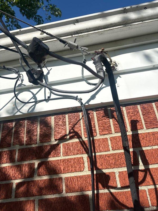 Responded to service call regarding circuit breaker producing abnormal noise. Upon arrival, conducted comprehensive inspection of main electrical panel and service entrance equipment. Examined exterior meter base, weatherproof disconnect box, and associated conduit connections mounted on building exterior. Inspected overhead service drop cables and their connection points at the soffit for signs of arcing, loose connections, or deterioration. Evaluated main panel interior for loose breaker connections, overheating indicators, and proper wire terminations. Identified source of audible noise, performed necessary corrections to eliminate hazard, and verified all connections were secure and functioning within normal parameters. System tested and confirmed operational.