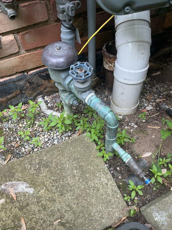 Performed annual backflow prevention device testing on exterior RPZ assembly per local code requirements. Unit passed all inspection criteria with proper check valve operation and pressure differential readings within acceptable parameters. Documented existing corrosion and oxidation on copper piping and brass fittings at outdoor backflow assembly. Additionally diagnosed interior plumbing issues including low water pressure at bathroom faucet and whistling noise from toilet during flush cycle, identifying potential aerator blockage and fill valve malfunction requiring future repair.