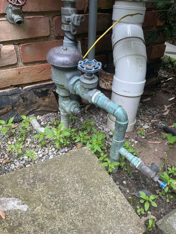 Performed annual backflow prevention device testing on exterior RPZ assembly per local code requirements. Unit passed all inspection criteria with proper check valve operation and pressure differential readings within acceptable parameters. Documented existing corrosion and oxidation on copper piping and brass fittings at outdoor backflow assembly. Additionally diagnosed interior plumbing issues including low water pressure at bathroom faucet and whistling noise from toilet during flush cycle, identifying potential aerator blockage and fill valve malfunction requiring future repair.