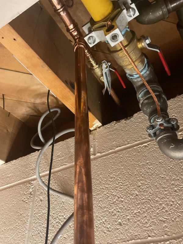 Replaced main water shutoff valve assembly in basement utility area. Coordinated with city water department for water service interruption to facilitate safe installation. Installed new brass valve body with red lever handles, connected copper supply piping, and integrated PVC fittings to existing plumbing infrastructure. Completed all soldering connections, tested system for leaks, and restored full water service to property.