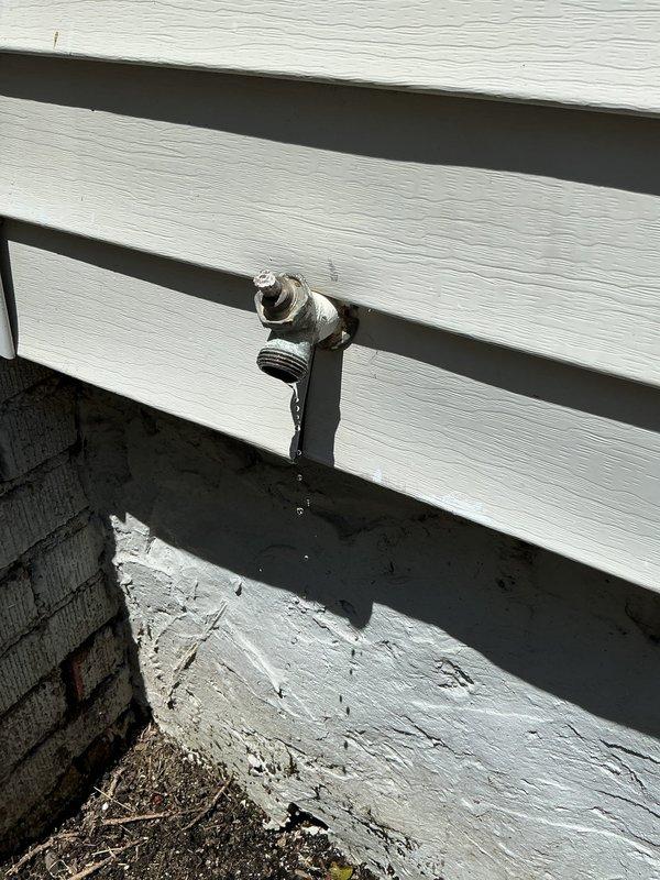 Replaced defective exterior hose bib mounted on home's siding due to failure of the outdoor water spout. Accessed plumbing connections through crawl space, disconnected old fixture from copper supply line, and installed new frost-free sillcock with proper sealing to prevent water intrusion through exterior wall penetration.