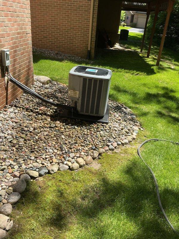 Completed comprehensive Gold AC Inspection on a two-year-old residential air conditioning unit located in the backyard. Performed full system diagnostics including refrigerant level verification, electrical connection inspection, condenser coil cleaning, air filter assessment, and thermostat calibration check. Verified proper operation of all components, confirmed adequate airflow through the system, and inspected the electrical disconnect box and conduit for safety compliance. Unit operating within manufacturer specifications with no issues identified. Documentation photos captured showing equipment condition and proper installation on gravel pad with appropriate clearances maintained.