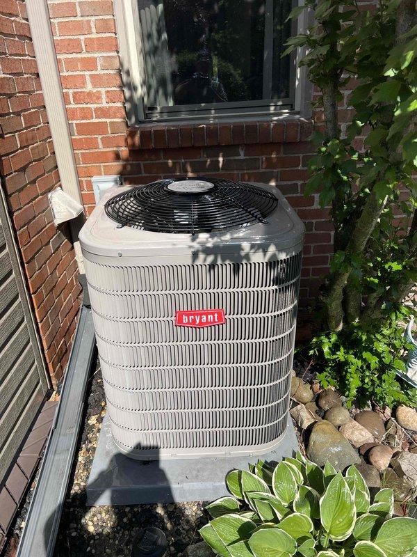 Completed comprehensive NSP AC inspection on single Bryant condensing unit with air handler located in basement. Inspected outdoor condenser unit positioned on concrete pad with proper clearance and landscaping maintenance, verified operational status of unit under 10 years old, examined evaporator coil and refrigerant line connections at indoor air handler, and provided complimentary air filters per maintenance agreement specifications.