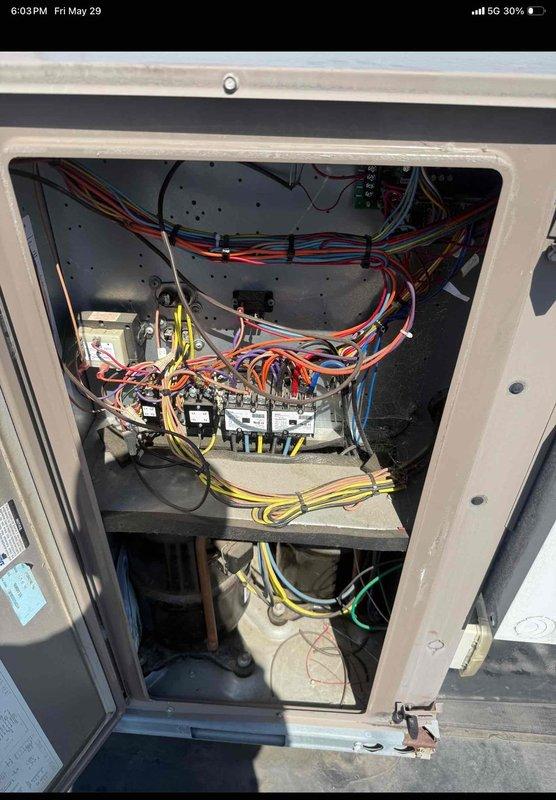 Performed commercial HVAC maintenance agreement service on single rooftop unit. Accessed RTU electrical control cabinet and inspected all electrical components, contactors, relays, and wiring connections. Verified proper operation of control systems and compressor components. Replaced air filters with new Koch brand pleated media filters installed in metal filter rack housing. All electrical connections found secure with no visible signs of wear or damage. Unit operational and system performing within normal parameters upon completion of maintenance inspection.