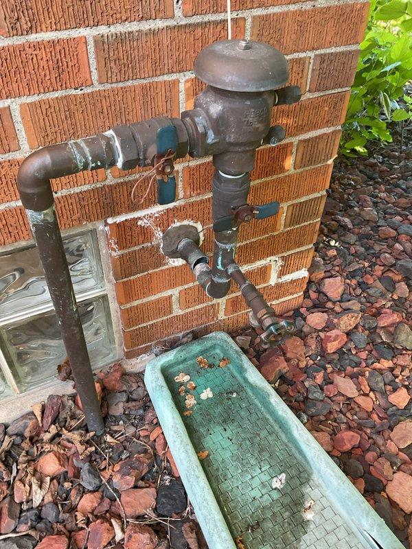 Responded to service call for copper piping repair on exterior of residence. Upon arrival, inspected copper pipe assembly located along brick exterior wall near gas meter installation. Identified compromised joint requiring soldering to restore system integrity. Successfully soldered copper piping connection, pressure tested repair to ensure proper seal, and verified no additional leaks present in surrounding pipe sections.