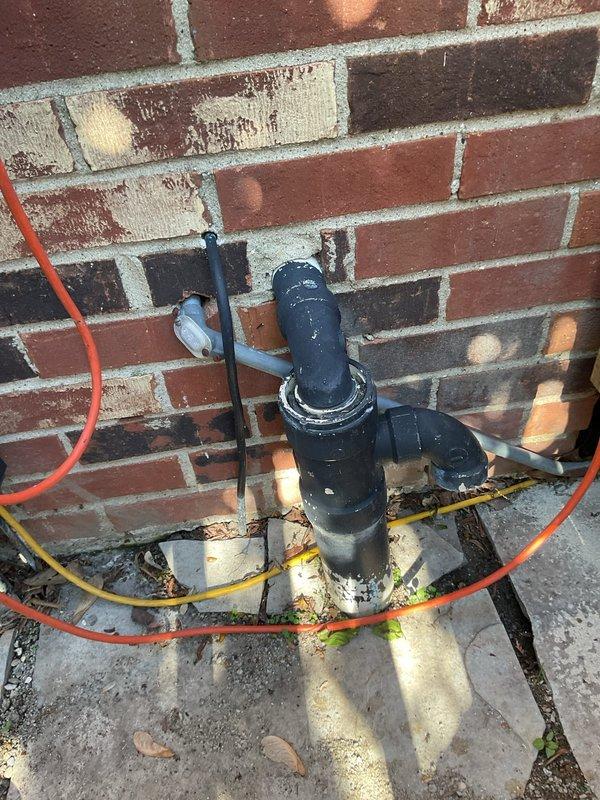 Responded to water leak complaint involving sump pump discharge line and slow-draining toilet. Inspected exterior PVC sump pump discharge assembly mounted on brick wall foundation and identified leaking connections at pipe joints. Replaced faulty fittings, check valve, and damaged PVC sections to eliminate water leakage at exterior discharge point. Verified interior sump pump operation and confirmed proper drainage flow through new piping assembly. Addressed slow toilet issue and completed system testing to ensure all plumbing functions restored to normal operation.