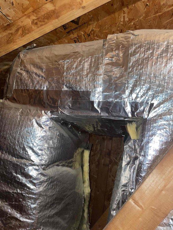 Responded to service call for air conditioning unit that would not turn on. Upon inspection, accessed attic space to evaluate approximately 10-year-old system with evaporator coil located in basement. Examined HVAC ductwork system with foil-backed insulation in attic area and inspected blower motor assembly with associated wiring and connections. Assessed system components including ductwork access points, electrical connections, and mechanical assemblies to determine equipment condition and provide replacement estimate for non-operational air conditioning system.