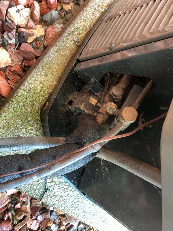 Completed comprehensive Gold AC inspection on 10-year-old single-unit air conditioning system with air handler located in basement. Performed thorough evaluation of outdoor condenser unit, which showed good overall condition with intact housing, properly secured fan guard, and functional components. Inspected refrigerant lines and associated piping in utility access area, noting age-appropriate weathering and surface oxidation on copper lines. Verified system operational status, documented equipment condition through photographic records, and confirmed all major components functioning as designed. Unit remains serviceable with normal wear patterns consistent with age of equipment.
