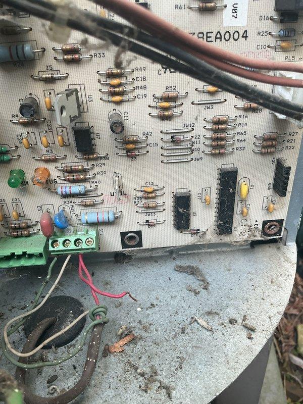 Responded to no-cooling call for 10+ year old air conditioning system being activated for first season following recent furnace installation in February. Upon inspection, found thermostat properly set to cooling mode at 75°F setpoint. Examined outdoor condensing unit and indoor evaporator coil circuit board, which showed signs of age with dust accumulation and minor corrosion on mounting surfaces. Verified thermostat wiring connections at both wall unit and control board terminal block, confirmed proper voltage supply, and tested system operation. Unit successfully started and began cooling cycle after addressing low-voltage control circuit issue.
