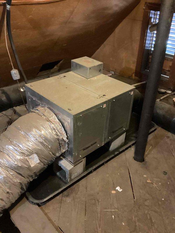 Conducted comprehensive assessment of existing Unico/Spacepak high-velocity HVAC system located in attic space. System evaluation revealed R22 refrigerant deficiency causing evaporator coil freezing, along with customer-reported issues of inadequate performance and excessive operational noise. Documented existing equipment configuration including air handler installation on wooden platform with flexible ductwork connections. Photographed electrical service panel and attic-mounted unit to support replacement estimate. Provided customer with options for complete system replacement due to obsolete R22 refrigerant, chronic performance issues, and noise concerns inherent to current high-velocity system design.