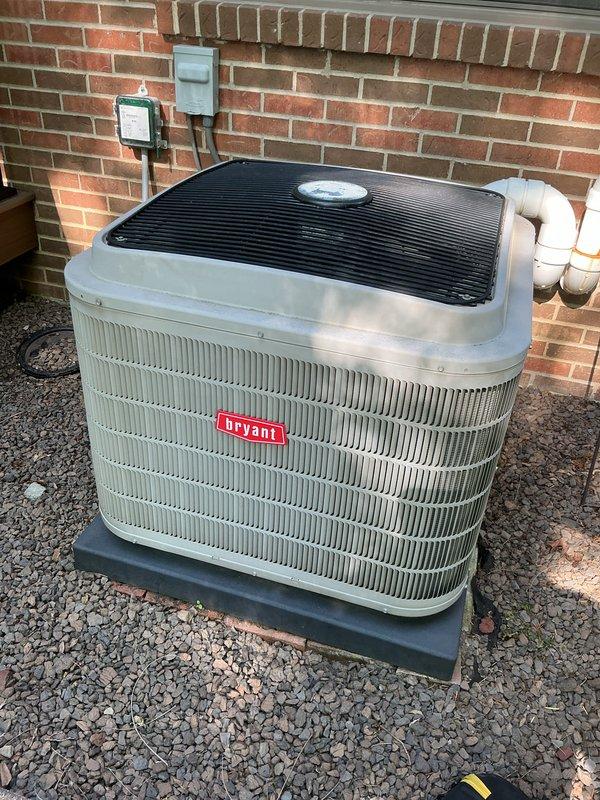 # HVAC Maintenance - Gold AC Inspection

Completed comprehensive Gold-level preventive maintenance inspection on 10-year-old Bryant air conditioning system during scheduled morning service window. Performed full AC tune-up protocol including visual inspection of outdoor condenser unit, verified proper installation on equipment pad with adequate gravel drainage bed, checked electrical connections at wall-mounted disconnect and junction boxes, and inspected PVC condensate drain lines for proper routing and drainage. Unit exterior showed good condition with clean cabinet panels and protective fan cover intact. All system components photographed for service documentation. System operational and ready for cooling season under active service plan coverage.