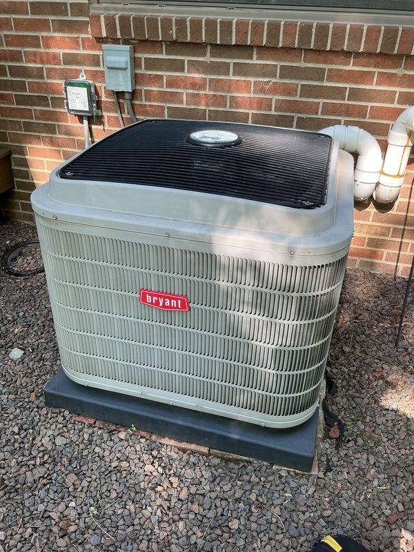 # HVAC Maintenance - Gold AC Inspection

Completed comprehensive Gold-level preventive maintenance inspection on 10-year-old Bryant air conditioning system during scheduled morning service window. Performed full AC tune-up protocol including visual inspection of outdoor condenser unit, verified proper installation on equipment pad with adequate gravel drainage bed, checked electrical connections at wall-mounted disconnect and junction boxes, and inspected PVC condensate drain lines for proper routing and drainage. Unit exterior showed good condition with clean cabinet panels and protective fan cover intact. All system components photographed for service documentation. System operational and ready for cooling season under active service plan coverage.