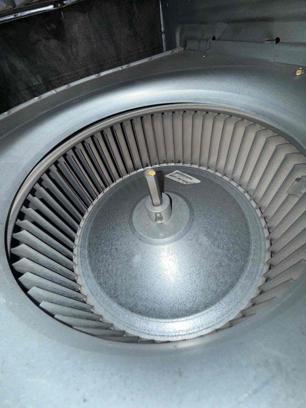Responded to no cooling complaint on 10+ year old AC unit located in basement. Upon inspection, found blower wheel assembly operational but discovered significant rust and corrosion buildup inside condensate drain line, indicating long-term moisture accumulation and potential drainage issues. Documented equipment condition with photos showing blower assembly in clean operational state and severely corroded PVC drain pipe interior. Advised property owner of findings and recommended drain line cleaning and system evaluation to prevent future drainage problems that could lead to water damage or system shutdown.