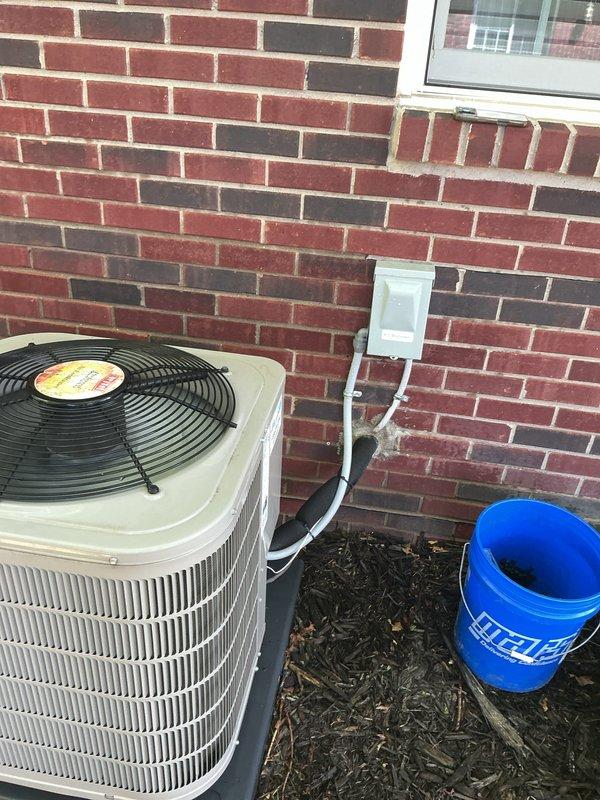 Completed comprehensive Gold AC Inspection on 6-year-old residential air conditioning system with air handler located in basement. Performed thorough evaluation of outdoor condenser unit, verified operational status of compressor and condenser fan motor, inspected electrical disconnect and associated wiring, and assessed indoor air handler components and condensate drain system. Advised customer to maintain clear area around condenser unit free of debris and animal waste to ensure proper airflow and system efficiency.