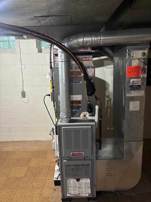Completed installation of 2.5-ton air conditioning system with matching evaporator coil on right side of existing Arcoaire furnace in basement mechanical room. Installed new thermostat, condensate pump with PVC drain line, and performed electrical reconnection of all components. Mechanical, electrical, and air conditioning permits were requested and system was tested for proper operation upon completion.