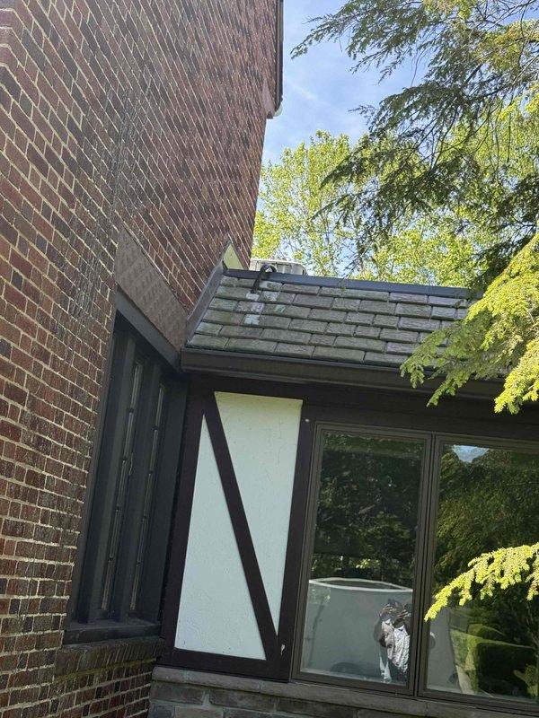 Responded to no cooling call on 20+ year old air conditioning system located in basement. Upon arrival, confirmed outdoor fan motor failed to operate when unit was powered on. Inspected condensing unit on roof, found fan motor seized and capacitor tested out of specification. Replaced failed condenser fan motor and dual run capacitor. Verified proper amperage draw, tested system operation through complete cooling cycle, and confirmed adequate airflow and normal operating pressures. Unit restored to full cooling operation.