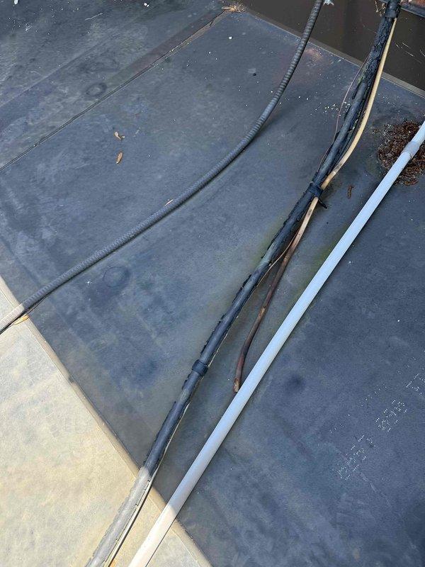 Responded to no cooling call on 20+ year old air conditioning system located in basement. Upon arrival, confirmed outdoor fan motor failed to operate when unit was powered on. Inspected condensing unit on roof, found fan motor seized and capacitor tested out of specification. Replaced failed condenser fan motor and dual run capacitor. Verified proper amperage draw, tested system operation through complete cooling cycle, and confirmed adequate airflow and normal operating pressures. Unit restored to full cooling operation.