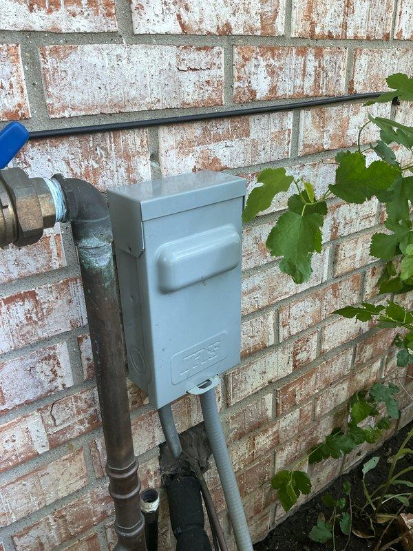 Completed comprehensive Gold AC inspection on residential air conditioning system with outdoor condenser unit and basement coil location. Performed thorough visual examination of exterior condenser unit, verified operational status of equipment, inspected electrical disconnect box and associated conduit connections mounted on exterior wall, and documented current condition of all accessible components. System found to be operational with no immediate service concerns identified during inspection.