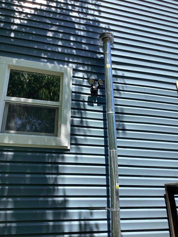 Provided estimate for replacement of improperly sized furnace and 50-gallon water heater located in basement. Existing 10+ year old equipment was incorrectly sized when previously installed. Quote includes natural gas furnace replacement with proper sizing calculations and new water heater installation, including necessary venting modifications as observed in exterior exhaust stack and electrical panel assessment for adequate circuit capacity.