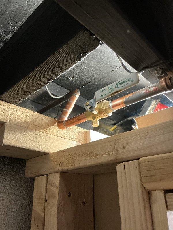 Completed water meter rebuild at residential property. Removed and replaced existing water meter assembly, including installation of new copper piping connections and shut-off valves. Installed new meter housing unit with mounting brackets, securing it to floor joist structure in crawlspace area. Configured brass fittings and compression connections to ensure proper integration with existing copper supply lines. Verified all connections for proper seal integrity and tested system for leaks. Meter now operational with full flow capacity restored.