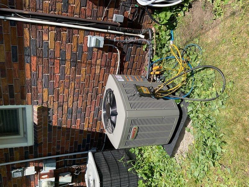 Completed a two-day installation of a 1.5-ton air conditioning system with evaporator coil at a residential property. The new outdoor condenser unit was positioned on a concrete pad against the brick exterior with proper refrigerant line connections, electrical conduit routing, and system flush performed. All mechanical, electrical, and air conditioning permits were obtained, and the unit was reconnected and tested for proper operation upon completion.