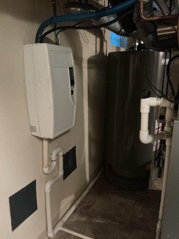 Responded to no cooling complaint on 20+ year old residential AC system located in basement. Upon arrival, performed diagnostic evaluation of the air conditioning unit and associated HVAC equipment. Inspected furnace, ductwork, condensate drainage system, and related mechanical components. Assessed overall system operation, airflow distribution, and cooling performance. Documented equipment condition through photographic evidence showing furnace with ductwork, water heater, humidifier unit, and PVC condensate piping throughout mechanical room. Evaluated age-related wear on system components and identified potential factors contributing to inadequate cooling output. Provided technical assessment and recommendations to homeowner regarding system performance issues and available options for restoring proper cooling operation.