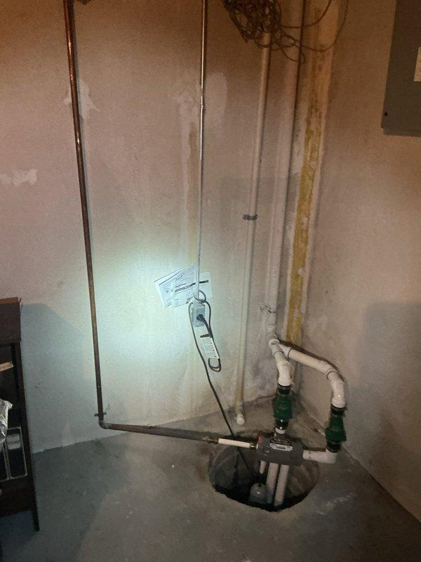 Responded to service call for handicap toilet installation quote at residential property. Conducted on-site assessment of existing bathroom configuration, which features standard height toilet with white subway tile and mosaic tile walls. Evaluated current fixture placement, clearance requirements, and accessibility needs for ADA-compliant toilet installation. Inspected basement plumbing infrastructure including main drain lines and water supply routing via sump pump area to determine feasibility of fixture replacement. Provided homeowner with detailed quote for removal of existing standard toilet and installation of ADA-compliant handicap-accessible toilet unit meeting required height specifications and grab bar mounting provisions.
