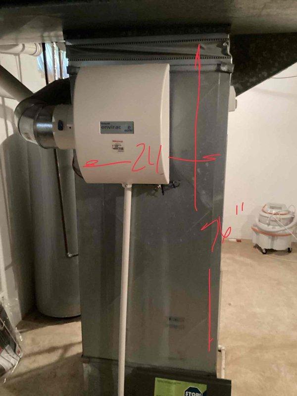 Provided comprehensive replacement estimate for 20-year-old basement-installed natural gas furnace and air conditioning system experiencing freezing issues on the outdoor condenser unit. Assessed existing HVAC configuration including wall-mounted humidifier, ductwork connections, and outdoor condenser positioned on ground-level pad adjacent to building foundation. Documented equipment specifications, measurements, and installation requirements for complete system replacement to restore proper cooling functionality and improve overall heating and cooling efficiency.