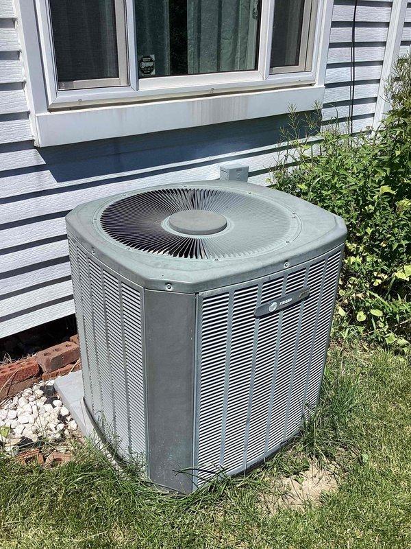 Provided comprehensive replacement estimate for 20-year-old basement-installed natural gas furnace and air conditioning system experiencing freezing issues on the outdoor condenser unit. Assessed existing HVAC configuration including wall-mounted humidifier, ductwork connections, and outdoor condenser positioned on ground-level pad adjacent to building foundation. Documented equipment specifications, measurements, and installation requirements for complete system replacement to restore proper cooling functionality and improve overall heating and cooling efficiency.
