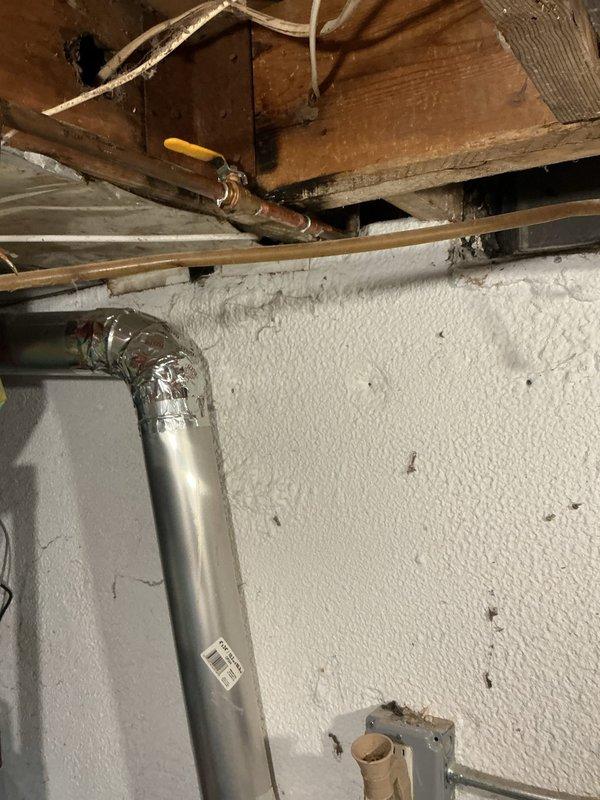 Responded to service call for leaking water heater in basement utility area. Upon inspection, found existing 40-gallon residential tank-style water heater with active leak at base and visible water damage on concrete floor surrounding unit. Water supply had been shut off to unit prior to arrival. Assessed unit for potential repairs but determined leak originated from tank failure, rendering unit non-repairable. Provided estimate for replacement and received approval to proceed with same-day installation.

Removed failed water heater and prepared installation area. Installed new 40-gallon residential gas-fired tank water heater in same location. Connected cold water supply line and hot water outlet using appropriate copper piping and fittings. Installed temperature and pressure relief valve with proper discharge piping termination. Connected existing gas line using flexible gas connector with yellow coating, ensuring all connections met code requirements. Verified proper venting configu