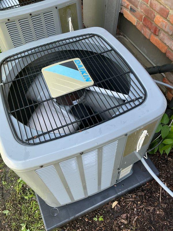 Completed comprehensive Gold AC inspection on two residential air conditioning units, both less than 10 years old and operational at time of service. Performed multi-point inspection protocol on outdoor condenser units including visual assessment of cabinet condition, fan grille guards, mounting pad stability, and proper drainage system function. Verified both units positioned on appropriate plastic mounting pads with adequate clearance for airflow and service access. Inspected condensate drain lines, electrical connections, and surrounding area for proper installation standards. Both systems confirmed operational with no immediate concerns identified during inspection. Documentation and photographic records completed for service file.