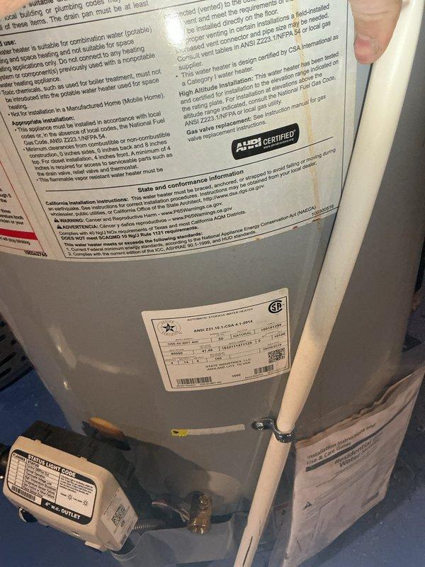 Replaced failed State brand tanked water heater that was leaking and compromised under existing 10-year warranty coverage. Documented model and serial numbers of both existing units with photographs, as one unit had previously been replaced with a Bradford White model. Installed new warranted replacement water heater with proper connections to existing copper supply lines, ensuring all plumbing connections, pressure relief valve, and control systems were properly configured and tested for operation.