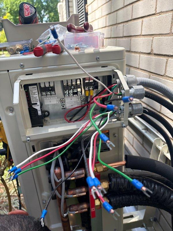 Completed three-head mini split system installation over three-day period in right side yard area. Obtained mechanical and electrical permits, installed new dedicated electrical circuit with breaker labeled "MINI SPLIT" in main panel, and mounted outdoor disconnect box with proper wiring connections. Installed refrigerant line sets with insulation, completed all electrical connections to code specifications, and documented installation with photos of electrical panel and outdoor disconnect components.