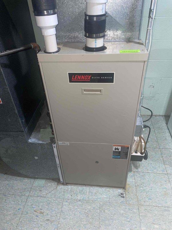 Completed comprehensive AC inspection and estimate for 1998 Bryant air conditioning system showing multiple critical failures including severely low refrigerant levels, outdoor fan motor drawing near maximum amperage, weakened capacitor, and burned/pitted contactor. Documented existing Lennox Elite Series furnace installation in basement utility area and assessed overall HVAC system condition for replacement recommendation.