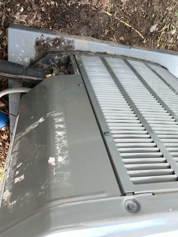 Responded to service call for AC short cycling and high fluctuating humidity issues on 5-year-old Trane system. Found standing water in outdoor condensate drain pan following recent installer adjustment; released drain plug to clear accumulated water. Performed AC tune-up including system inspection, cleaning of outdoor unit which showed weathering and debris accumulation, and verification of proper drainage function. Addressed humidity fluctuations displayed on Ecobee thermostat by ensuring condensate system was draining properly and system cycling was operating within normal parameters.