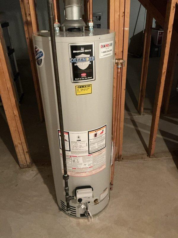 Corrected temperature and pressure relief valve discharge piping on Bradford White Defender water heater to comply with State of Michigan plumbing code requirements. Installed proper discharge pipe configuration and documented installation with photographs submitted to municipal building department for code compliance verification and inspection clearance.