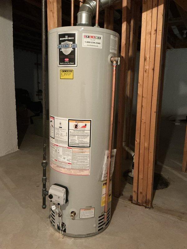 Corrected temperature and pressure relief valve discharge piping on Bradford White Defender water heater to comply with State of Michigan plumbing code requirements. Installed proper discharge pipe configuration and documented installation with photographs submitted to municipal building department for code compliance verification and inspection clearance.