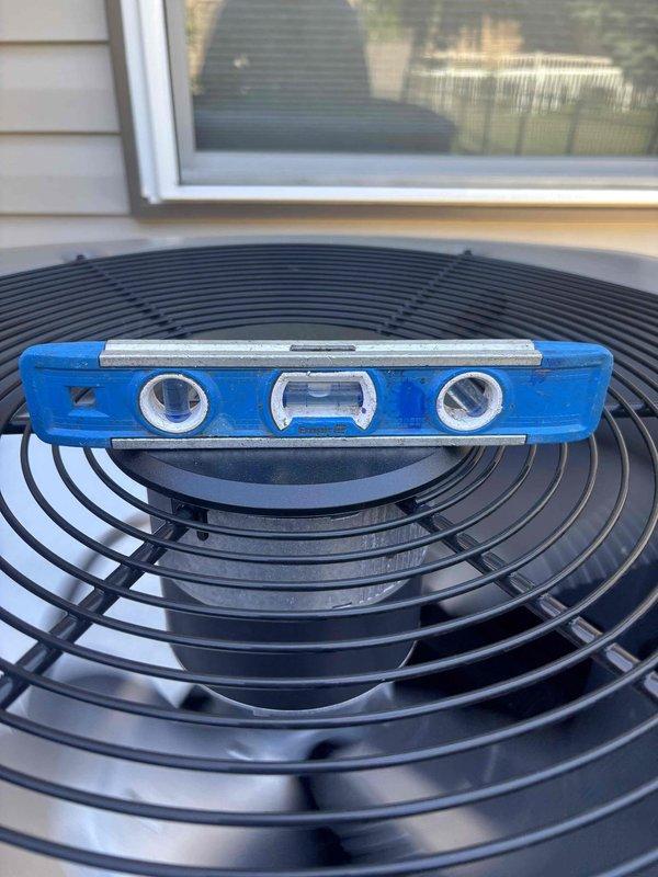 Completed air conditioning system start-up for basement evaporator coil installation. Verified proper unit leveling, checked refrigerant pressures and temperatures using digital manifold gauges, and confirmed system operation with readings of 95.8 psig low side and 224.6 psig high side with 116°F superheat measurement.