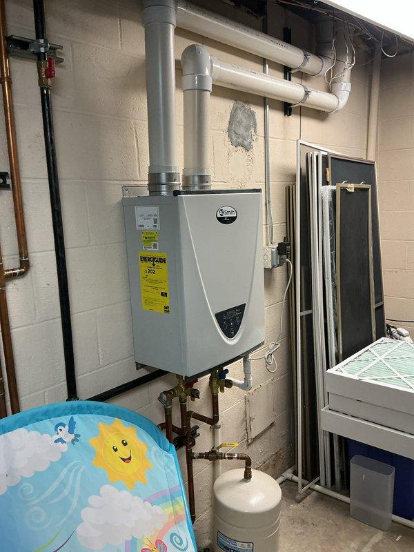 Completed comprehensive Gold AC Inspection on a multi-unit HVAC system consisting of two air handlers located in the basement, installed in 2020. Performed thorough visual inspection of all three gray metal air handler units, verified proper operation of equipment, inspected PVC condensate drain lines, ductwork connections, and electrical conduit for proper installation and function. Examined refrigerant line sets, control wiring, and safety shutoff valves, confirming all components were secure and operating within normal parameters. Documented system configuration including white PVC venting, copper and brass plumbing connections, and verified accessibility for future maintenance needs. All equipment found to be in good working condition with no immediate service concerns identified.